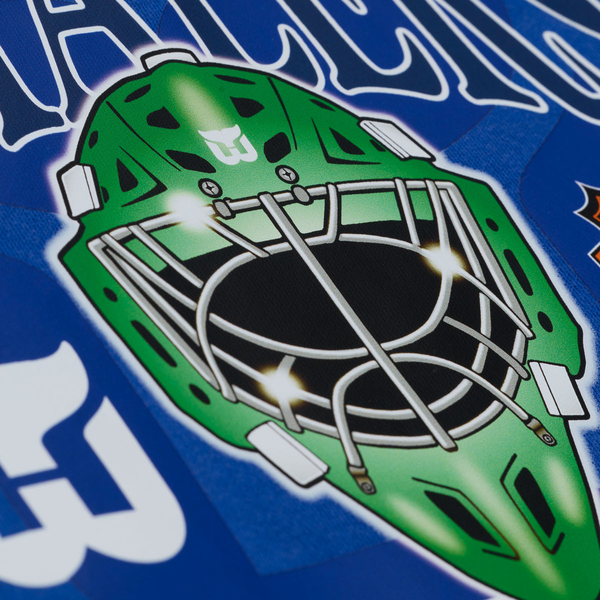 Close up of green goalie mask on front artwork