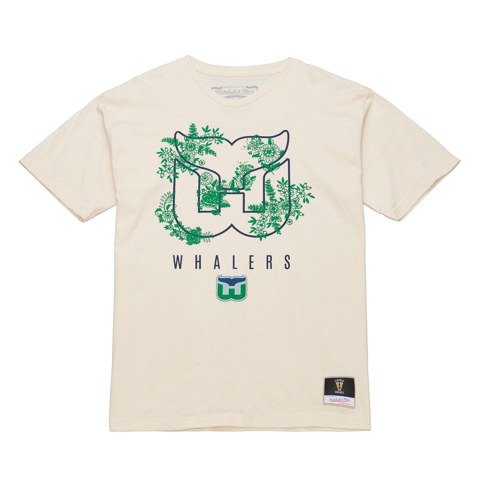 Front: Cream tee, Whalers tail outline logo with foliage, "WHALERS" with Tail logo beneath