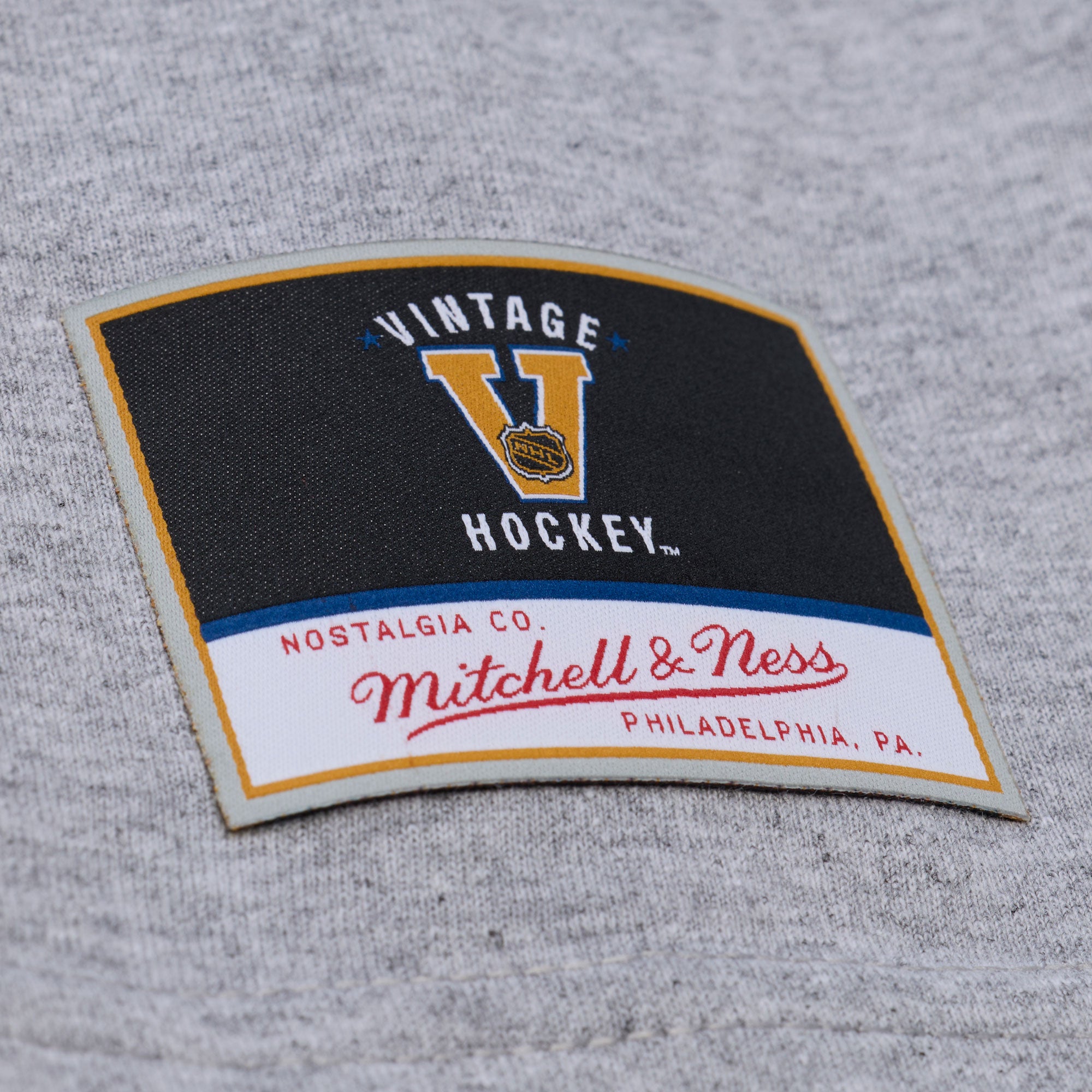 Close up of Vintage Hockey/Mitchell & Ness patch on front of shirt
