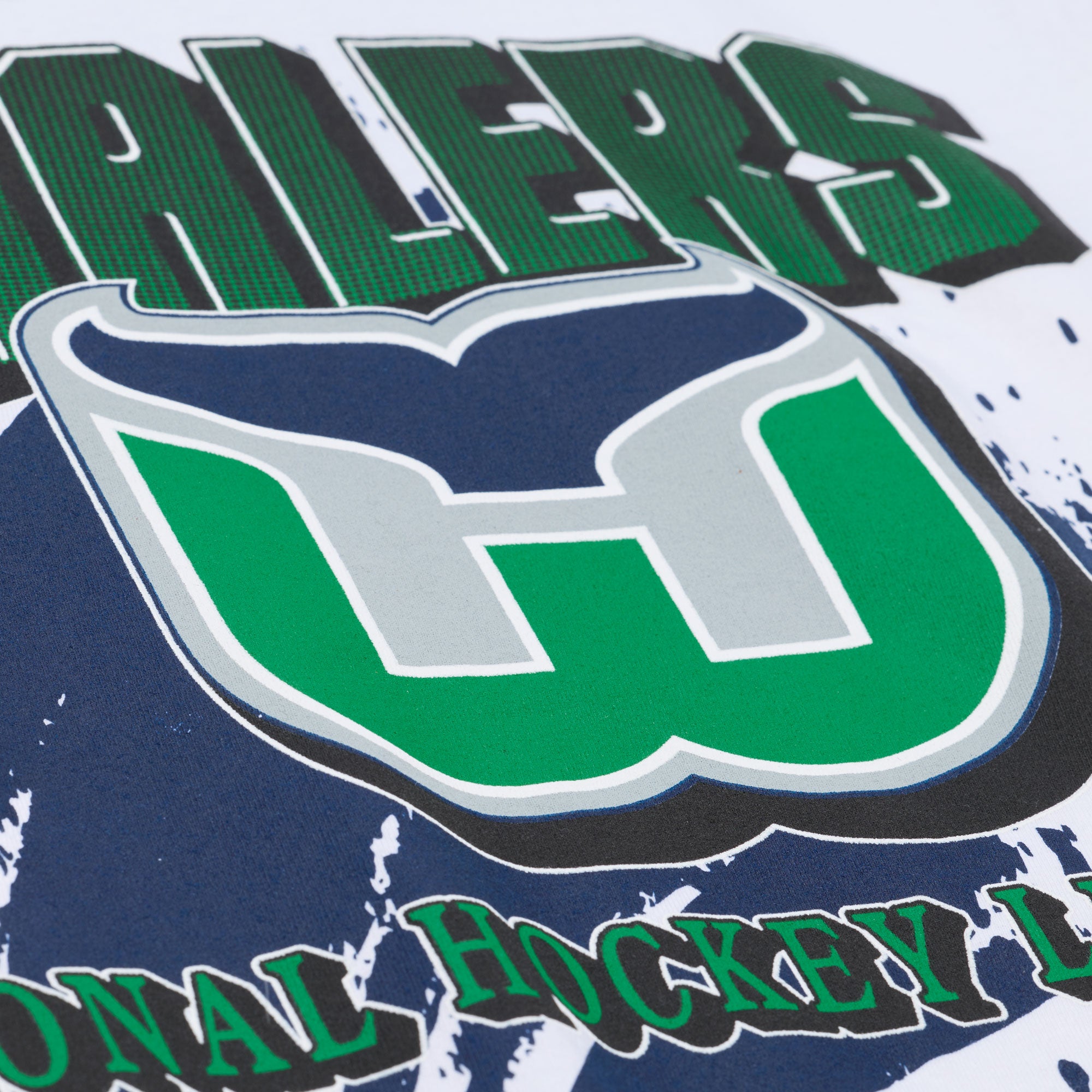 Close up of the art on the front, featuring the Whalers Tail logo