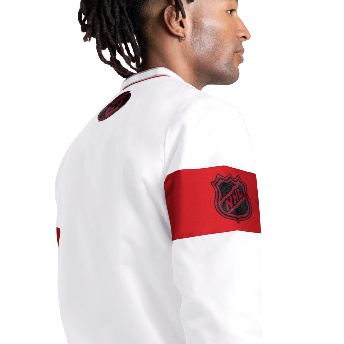 Right: Red/Black NHL Shield logo overtop of red stripe on sleeve