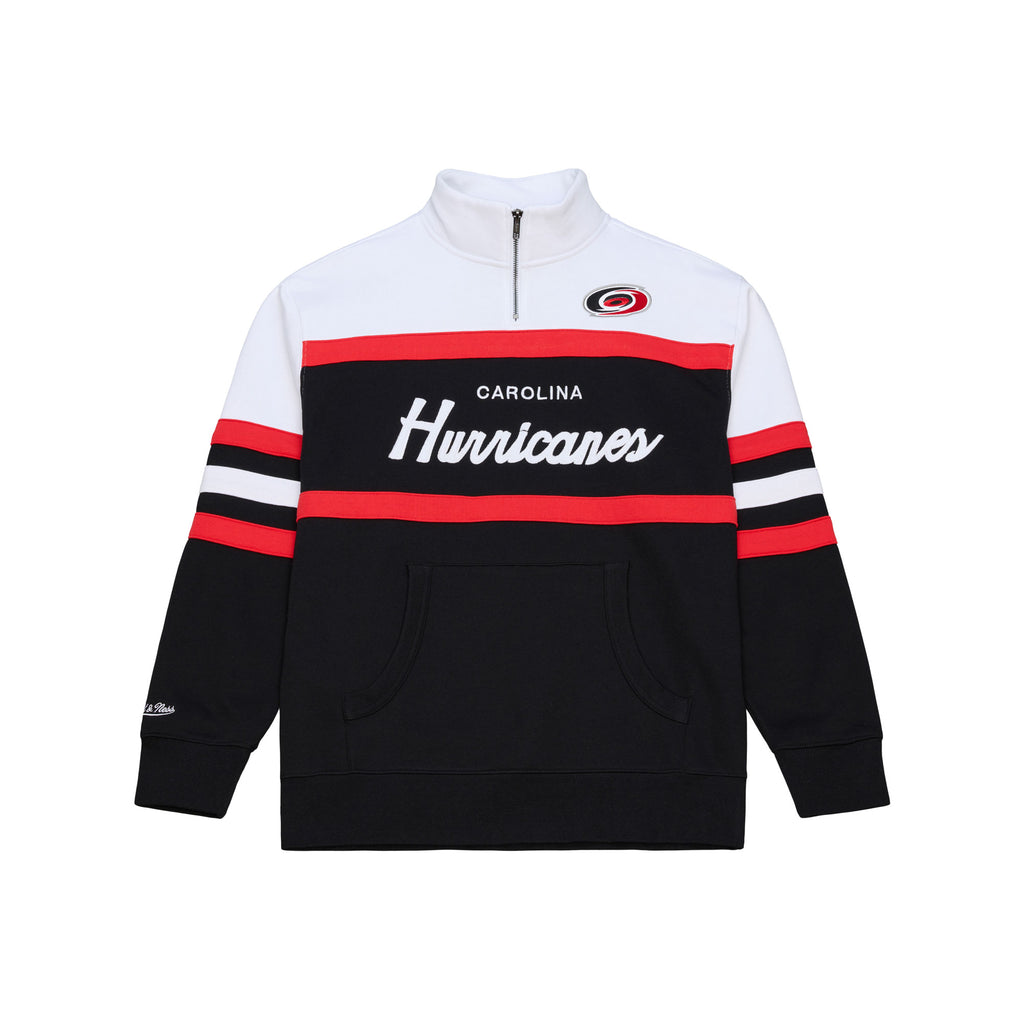 Front: Black quarter zip, red/white stripes, white shoulders, "Carolina Hurricanes" across chest