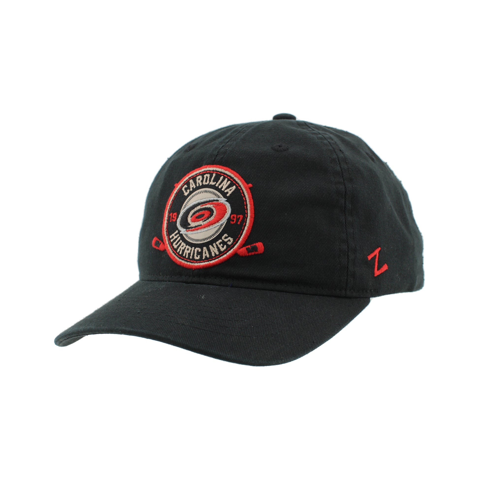 Side: Black hat with circular patch graphic on front, red Zephyr logo on left