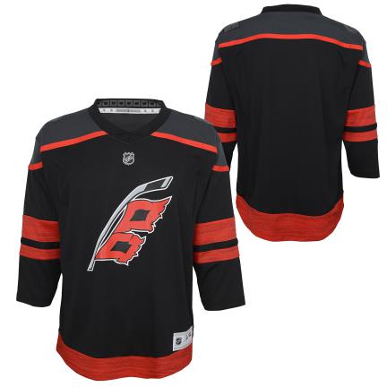 Front/Back: black jersey with dark gray shoulders and red trim, Flags logo on front