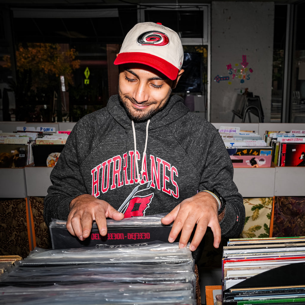 A model wearing the hat while inside a record store