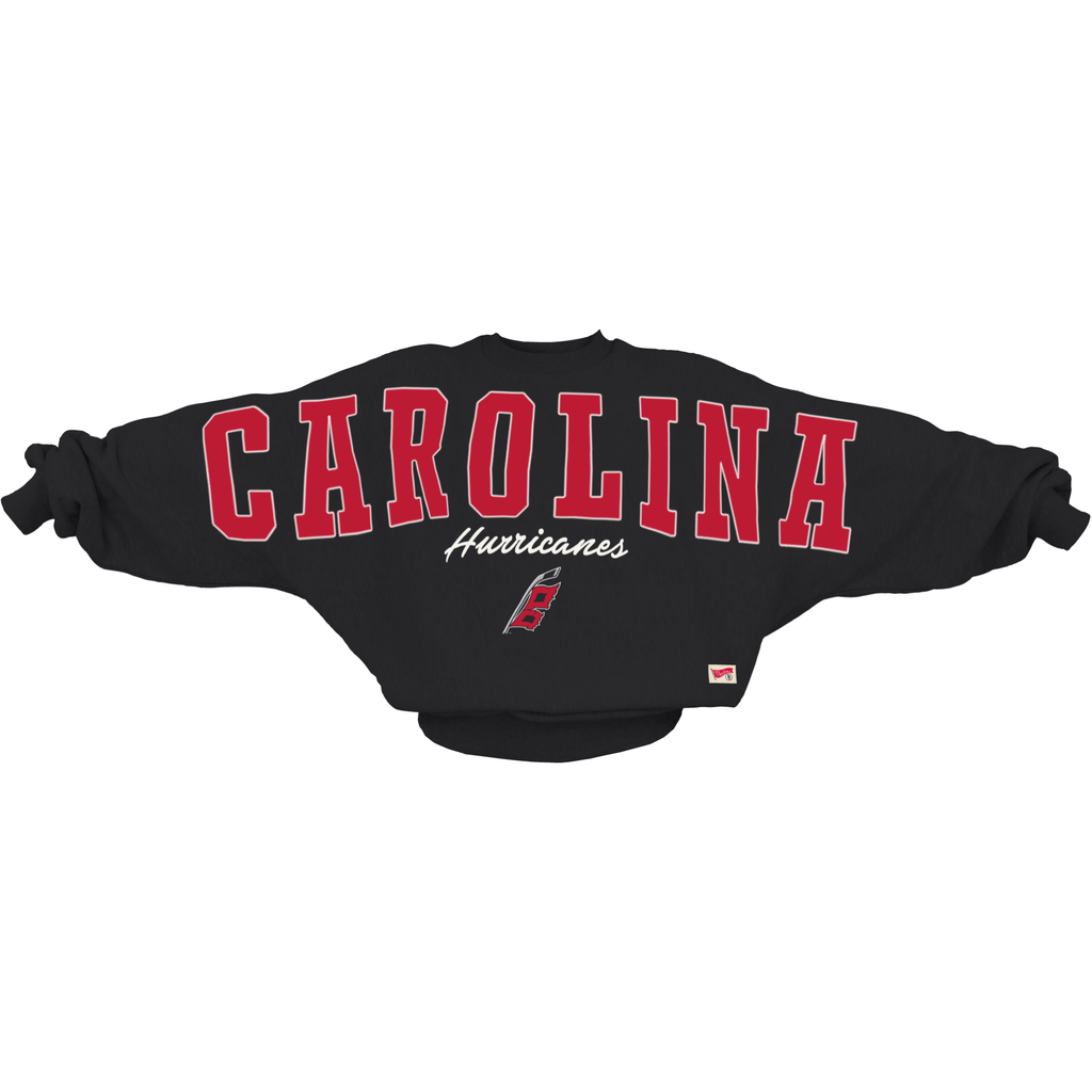Black oversized sweater, "CAROLINA" in red/white across chest/arms, "Hurricanes" in white, Flags logo