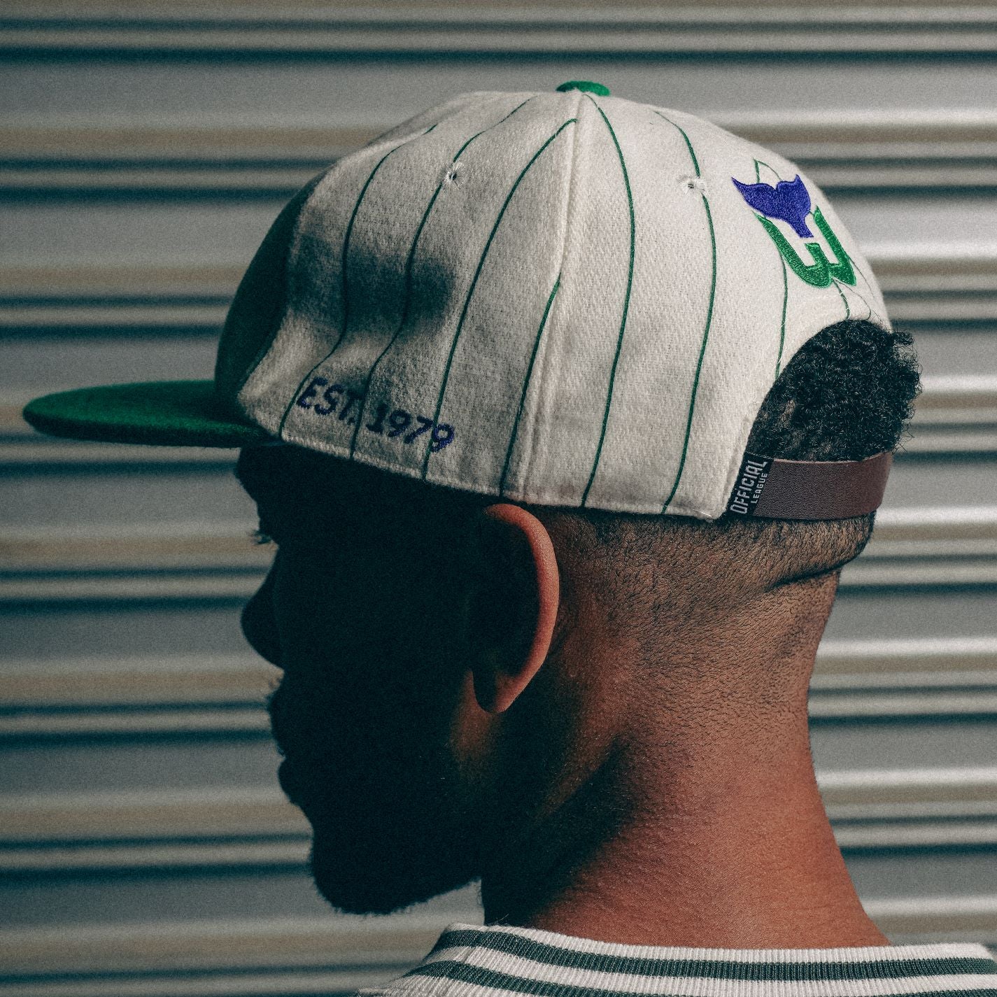 Back: Cream hat with green pinstripes, Whalers logo above leather adjustable strap