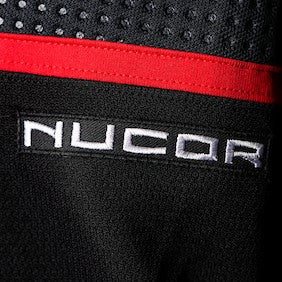 Black patch with NUCOR logo in white lettering