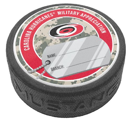 puck that says Carolina Hurricanes Military Appreciation with dog tag art