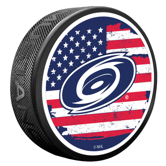 puck with American flag on top face with USA Blue and white Hurricanes primary logo