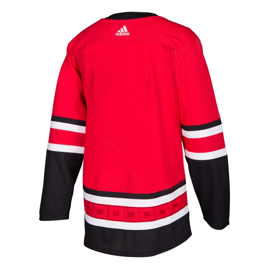 Back View: Red jersey with black/red stripes with white adidas logo at top
