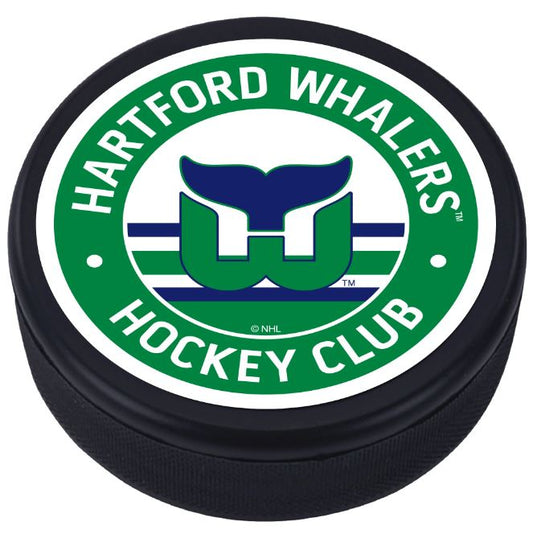 Hockey puck with the Whalers logo and their signature striping in the middle with "Hartford Whalers Hockey Club" on the outside of a white and green top face.