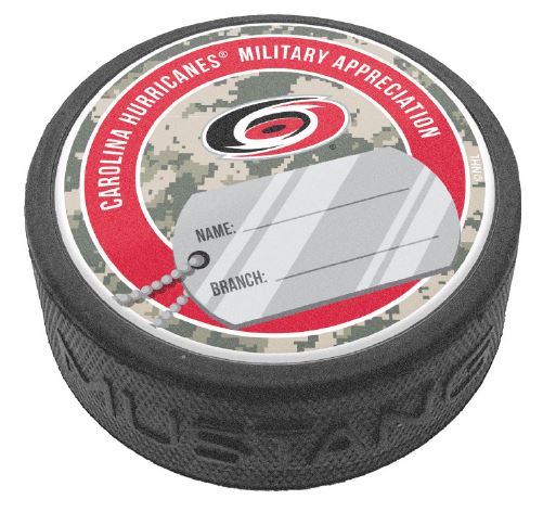 Hockey puck with the Hurricanes primary logo and a dog tag with space for personal writing on a green digital camo and red top face.