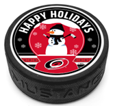 Hockey puck with a snowman in the middle and the phrase "Happy Holidays" on the top and the Hurricanes primary logo at the bottom of a red and black top face.