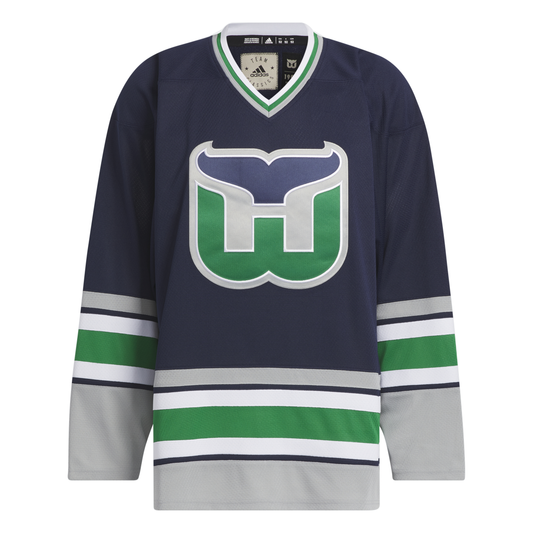 Front View: Navy blue jersey with Whalers logo and grey white and green striping.