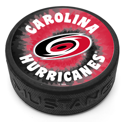 Hockey puck with a tie-dye backdrop and the Hurricanes Primary Logo with the words "Carolina Hurricanes" on the top face.